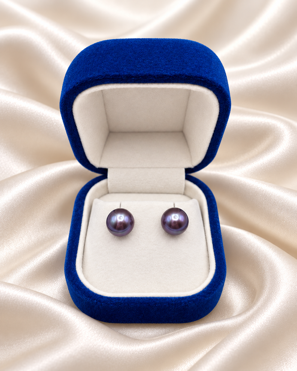The 11mm Purple Edison Freshwater Pearl Stud Earrings in a navy velvet Lespéra box