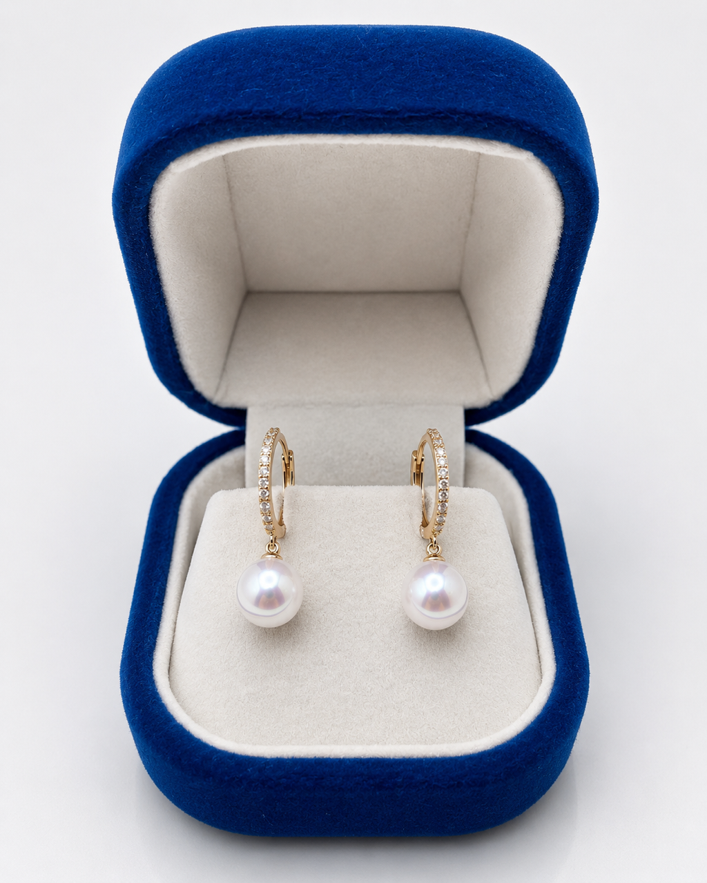 Pearl huggie drop earrings in a navy velvet gift box