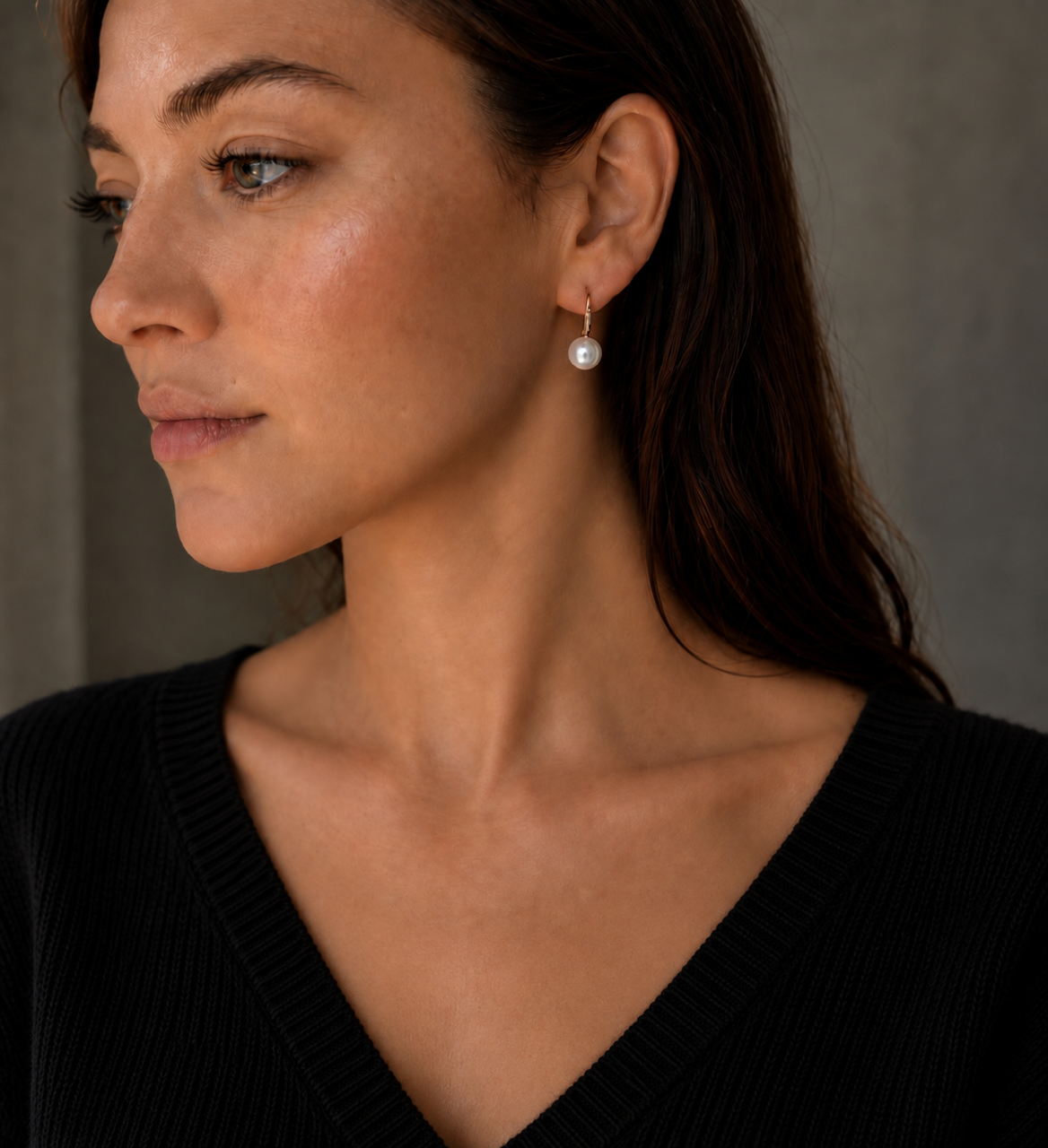 Model wearing the 9mm white pearl huggie drop earring